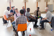 © Tom Merton/Caia Image - Men talking in group therapy in community center