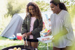 © Sam Edwards/Caia Image - Mother and daughter barbecuing at campsite