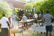 © Tom Merton/Caia Image - Male friends playing ping pong, enjoying backyard barbecue