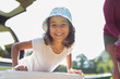 © Sam Edwards/Caia Image - Portrait confident, happy girl in sun hat