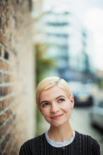 Portrait Confident, Curious Young Woman On Urban Sidewalk