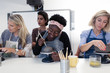 © Sam Edwards/Caia Image - Women shaping clay in art class