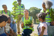 © Trevor Adeline/Caia Image - Happy volunteers planting trees and plants in sunny park