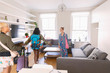 © Tom Merton/Caia Image - Young women friends with suitcases arriving at house rental