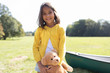 © Sam Edwards/Caia Image - Portrait smiling, cute girl with teddy bear in sunny field