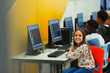 © Paul Bradbury/Caia Image - Portrait smiling, confident junior high girl student using computer in computer lab