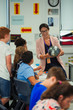 © Paul Bradbury/Caia Image - Female geography teacher with globe teaching lesson in classroom