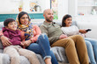 © Robert Daly/Caia Image - Family watching TV on living room sofa