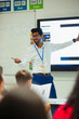 © Paul Bradbury/Caia Image - Smiling male teacher leading lesson in classroom