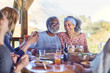 © Trevor Adeline/Caia Image - Happy senior couple enjoying healthy meal in hut during yoga retreat