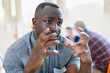 © Tom Merton/Caia Image - Serious young man talking, gesturing in group therapy