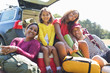 © Sam Edwards/Caia Image - Portrait happy family camping, unloading car