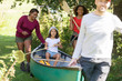 © Sam Edwards/Caia Image - Family carrying canoe in woods