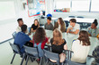 © Paul Bradbury/Caia Image - High school students talking in debate class at table in classroom