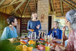 © Trevor Adeline/Caia Image - Friends enjoying healthy breakfast in hut during yoga retreat