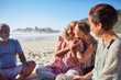© Trevor Adeline/Caia Image - Happy women hugging on sunny beach during yoga retreat