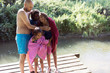 © Sam Edwards/Caia Image - Happy family drying off after a swim at sunny riverside