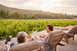 © Trevor Adeline/Caia Image - Couple relaxing, drinking wine on idyllic, rural resort patio