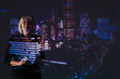 © Paul Bradbury/Caia Image - Double exposure businesswoman against highrise lights at night