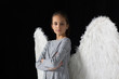 © Martin Barraud/Caia Image - Portrait confident, brave girl wearing angel wings