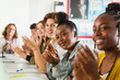 © Chris Ryan/Caia Image - High school students clapping in debate class