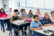 © Robert Daly/Caia Image - Junior high school students enjoying lesson at desks in classroom