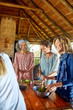 © Trevor Adeline/Caia Image - Women preparing healthy meal in hut during yoga retreat