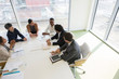 © Martin Barraud/Caia Image - Business people talking in conference room meeting