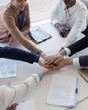 © Tom Merton/Caia Image - Business people joining hands in conference room meeting