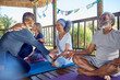 © Trevor Adeline/Caia Image - Yoga class meditating in hut during yoga retreat