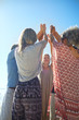 © Trevor Adeline/Caia Image - Group standing in circle with arms raised during yoga retreat