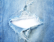 Ripped Torn Pattern Of Light Blue Denim Jeans On White Background