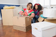 © Robert Daly/Caia Image - Mother and daughter taping moving boxes, moving house