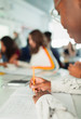 © Paul Bradbury/Caia Image - High school boy student taking notes, writing in notebook in classroom