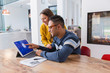 © Chris Ryan/Caia Image - Couple paying bills at digital tablet