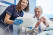 © Trevor Adeline/Caia Image - Doctor and nurse using digital tablet in clinic doctors office