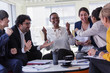 © Tom Merton/Caia Image - Excited business people cheering in meeting