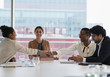© Tom Merton/Caia Image - Businesswomen shaking hands in conference room meeting