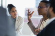 © Tom Merton/Caia Image - Businesswoman explaining in conference room meeting