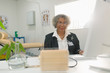 © Tom Merton/Caia Image - Portrait senior female doctor working at computer in doctors office