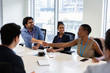 © Tom Merton/Caia Image - Business people shaking hands in conference room meeting