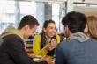 © Tom Merton/Caia Image - Happy young adult friends in cafe
