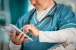© Chris Ryan/Caia Image - Male doctor using digital tablet