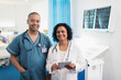 © Sam Edwards/Caia Image - Portrait confident doctors with digital tablet in hospital room