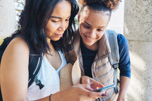 Young Women Friends Using Smart Phone