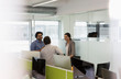 © Tom Merton/Caia Image - Business people talking, meeting in open plan office