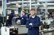© Himalayan Pics/Caia Image - Portrait confident teenage boy high school student in shop class