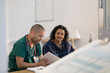 © Tom Merton/Caia Image - Doctors using digital tablet in clinic