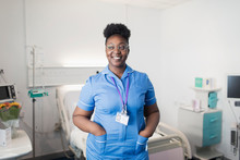 Portrait Confident, Smiling Female Nurse In Hospital Room