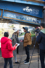 College Film Students Filming Under Urban Bridge